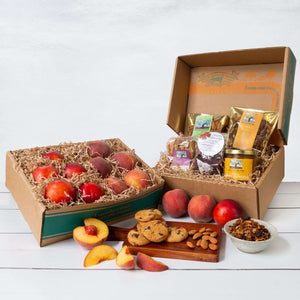 An image of two rustic gift baskets, the first one filled with juicy peaches and nectarines, and the second filled with packaged almonds, granola, cookies, and conserve.