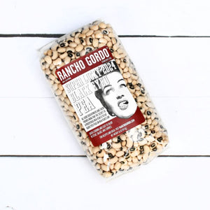Medium-sized dry beans featuring 1 black circle per bean in a bag on a white background