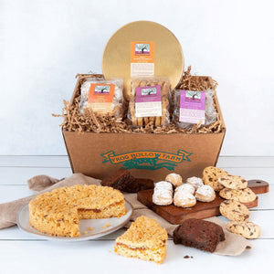 A visually appealing square image of a rustic gift basket featuring a variety of fresh baked goods.