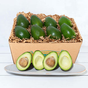 A rustic craft gift basket with Frog Hollow's logo, featuring vibrant avocados, highlighting their fresh and buttery texture.