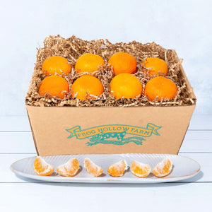 A square image featuring a rustic craft gift basket full of fresh mandarins, highlighting their vibrant orange skin.