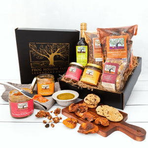 A bountiful display of colorful fruit conserves, olive oil, granola, dried fruit, and baked cookies, in an elegant Frog Hollow gift box.