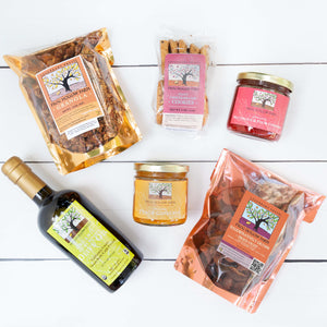 A flat lay image of packaged goods including granola, dried fruit, olive oil, cookies, and colorful fruit conserves.
