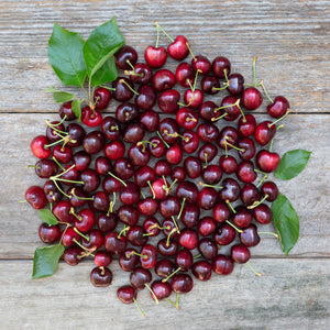 a cluster of cherries on barnboard
