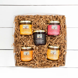A visually appealing flat lay of a conserve collection, showcasing jars of various fruit preserves.