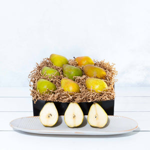A square image of vibrant and juicy organic pears, carefully arranged in an elegant gift box.